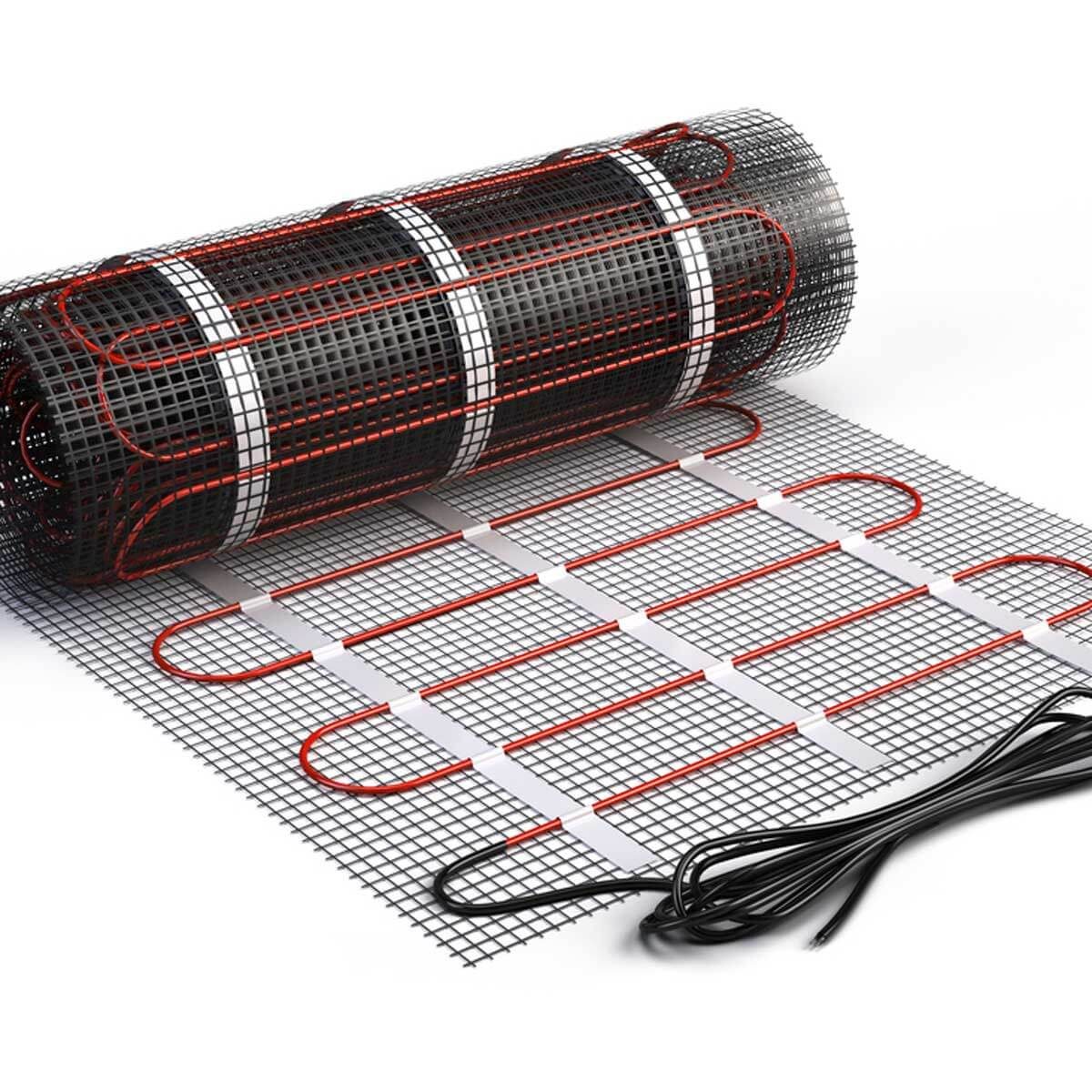 A rolled heating mat with black mesh and red heating wires is being uncoiled on a flat surface, ready for installation in a floor heating system.