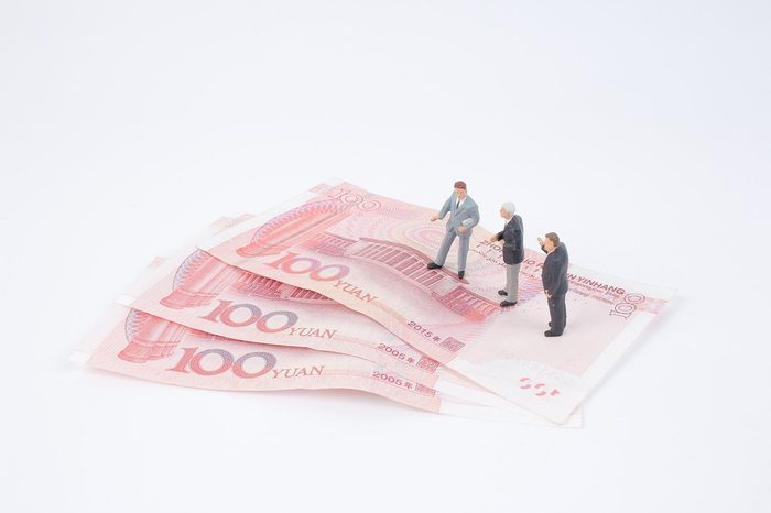 the group of Mini business men on bank notes
