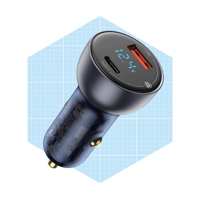 A dual-port car charger displays charging status on top, with a USB port and Type-C connector, set against a light blue grid background.