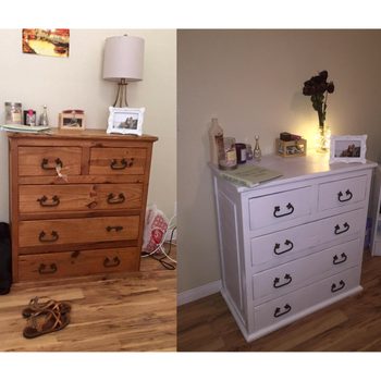 Two dressers sit side by side, one wooden and the other white, both topped with decorations in different, softly lit rooms.