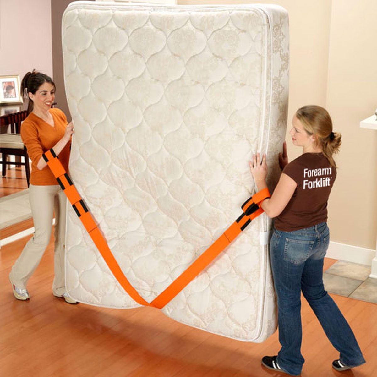 Two women using the simple model of Forearm Forklift moving straps
