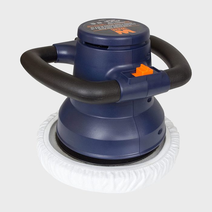 A circular polishing tool with a soft white pad is positioned upright, featuring a blue body and black handles, ready for use in surface cleaning.