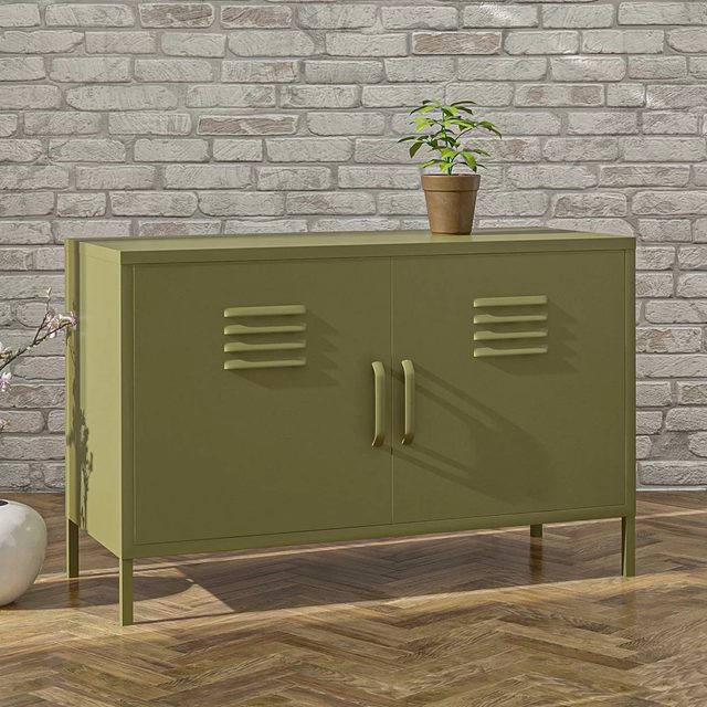 A green cabinet with slatted doors holds a potted plant on top, set against a textured brick wall and wooden floor.