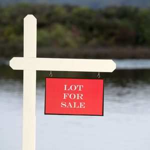 A white post supports a red sign displaying 