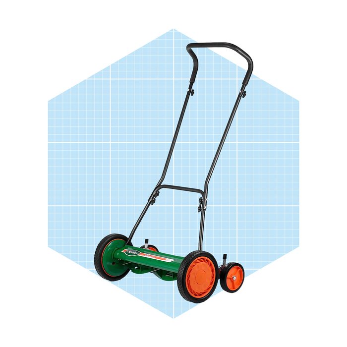 A green manual push mower with orange wheels stands upright against a light blue grid background, ready for use in maintaining a lawn.
