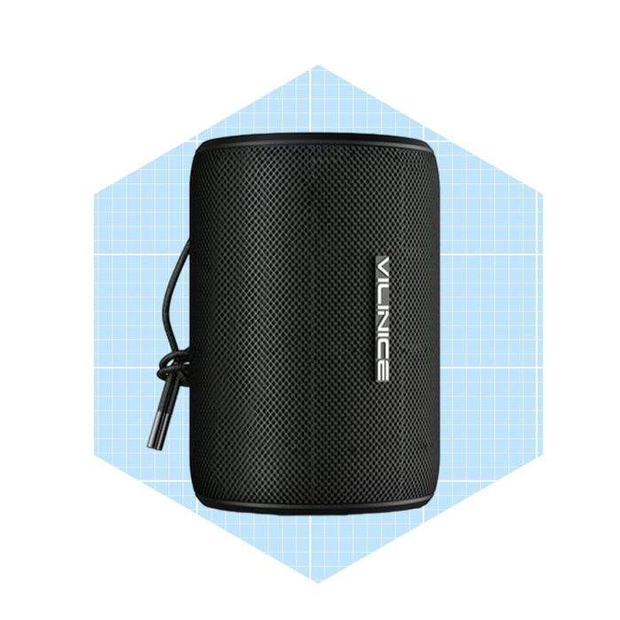 A cylindrical black portable speaker is displayed, featuring a branding logo. It sits against a light blue grid background, emphasizing its design.