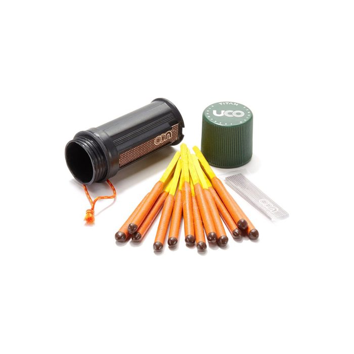 A black waterproof container holds safety matches beside a green cap and a striking surface. Matches, with brown tips and yellow sticks, are neatly arranged.