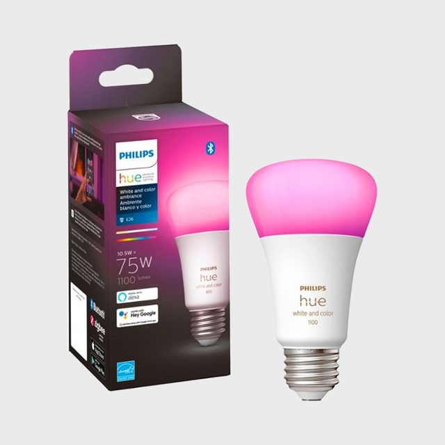 A smart LED light bulb emits a pink glow, displayed beside its packaging, which details features like Bluetooth connectivity and compatibility with voice assistants.