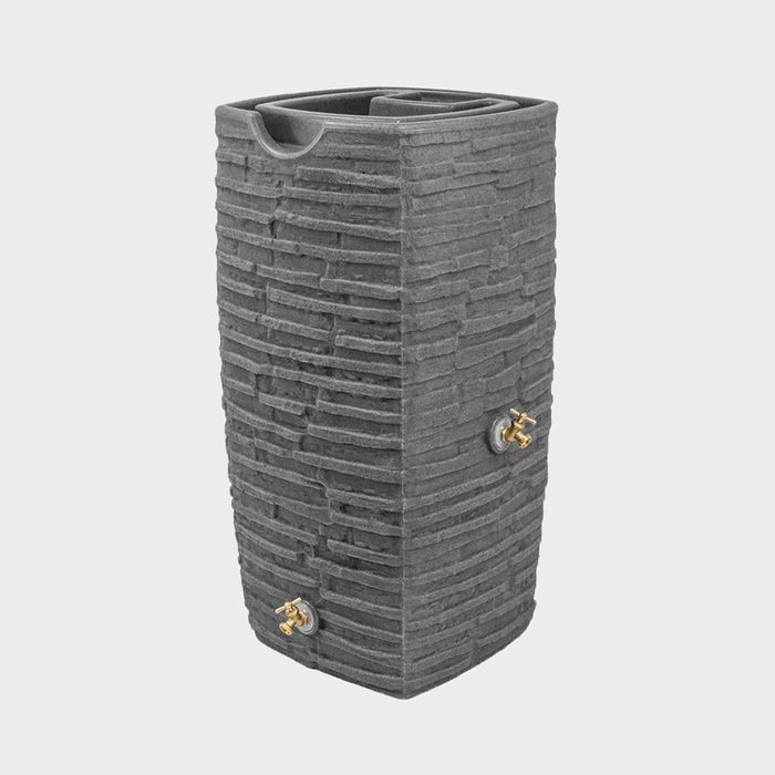A tall, rectangular planter with a textured gray surface sits upright. It features two gold-colored valve connections on one side, suggesting a functional design.