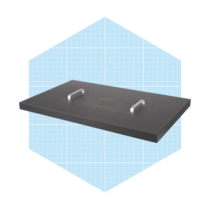 A rectangular griddle with two metallic handles rests above a light blue grid background, suggesting a sturdy cooking surface designed for grilling food.