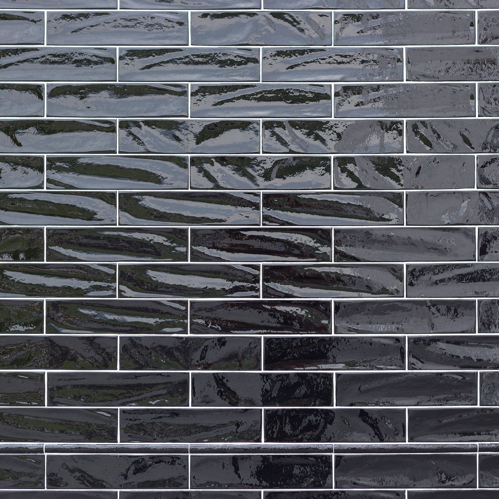 Glossy black tiles form a sleek wall surface, reflecting light subtly while arranged in a staggered pattern across the area.