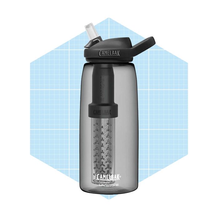 A gray water bottle with a filter attached at the top is standing upright against a light blue grid background.