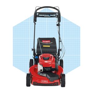 A red lawn mower stands upright, featuring a black engine cover and a handle labeled 