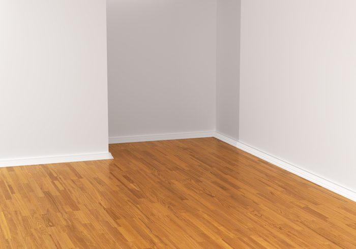 Empty white room with wooden floor.