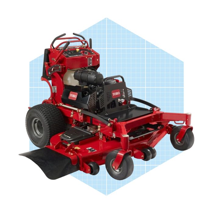 A red lawn mower sits on a surface, equipped with a robust engine and controls, surrounded by a light blue grid pattern.