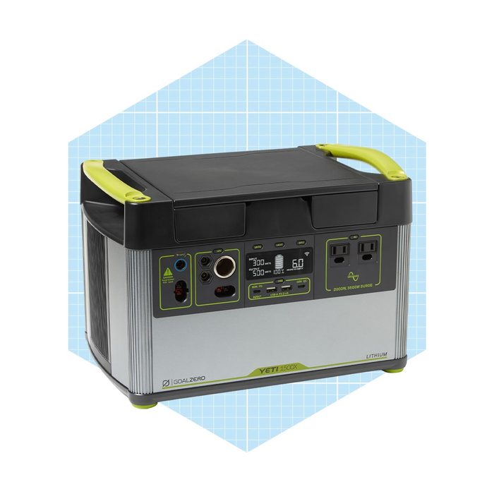 A compact power station with various output ports, displaying a digital interface, placed against a light blue geometric background, designed for portable energy solutions.
