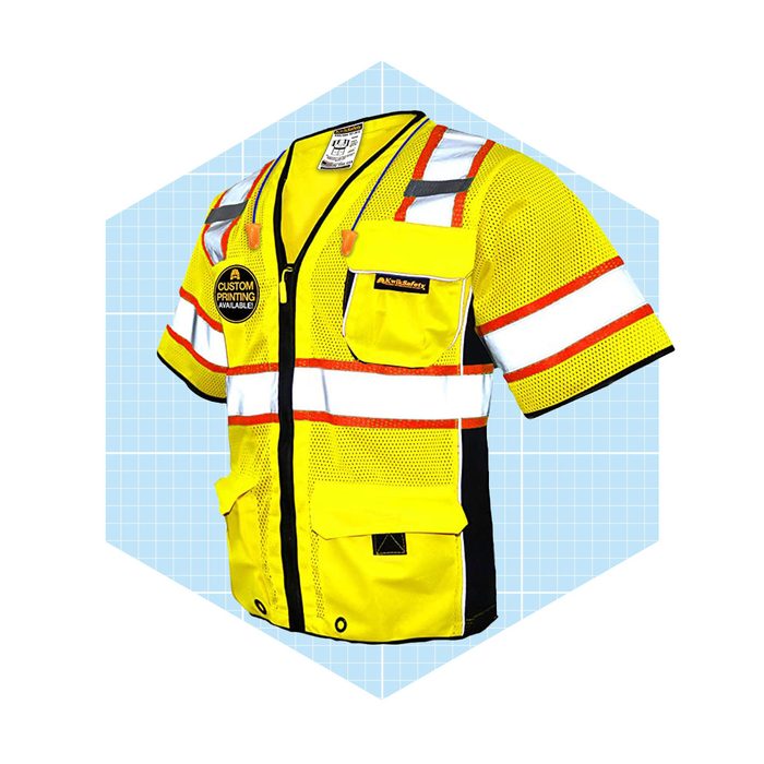 A high-visibility safety vest is displayed, featuring bright yellow fabric, reflective stripes, and multiple pockets, set against a light blue grid background.