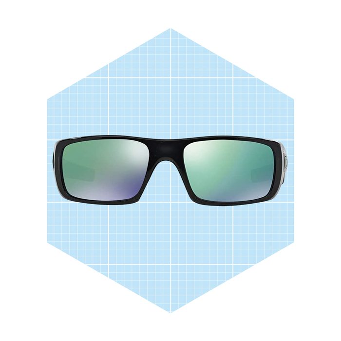 Stylish sunglasses are positioned centrally, displaying mirrored lenses. They are set against a light blue grid background.