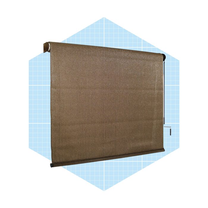 A textured brown roller blind hangs vertically, partially exposed, within a light blue hexagonal background featuring a grid pattern.