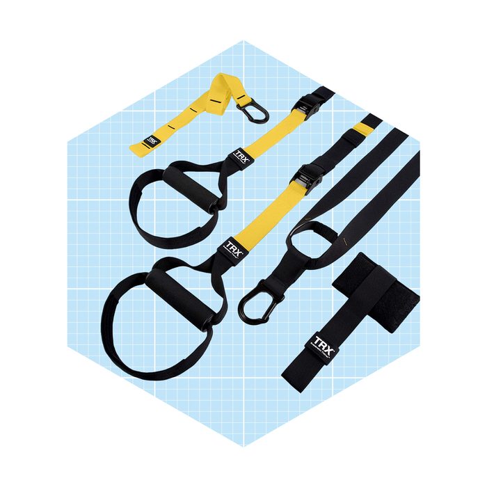 Suspension training straps are displayed, ready for use, on a light blue grid background, showcasing various components including handles and attachment points.