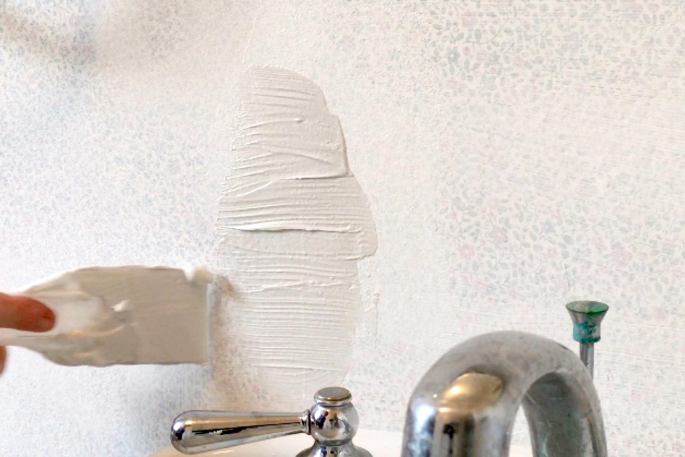 repairing holes with putty knife