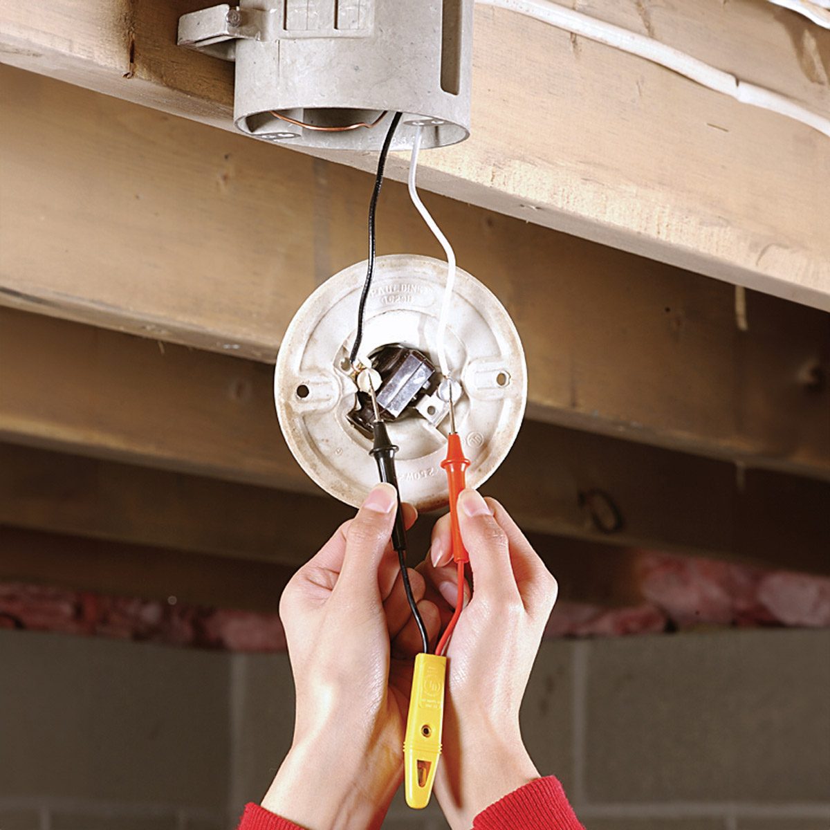 Light Fixture being checked with a voltage tester.