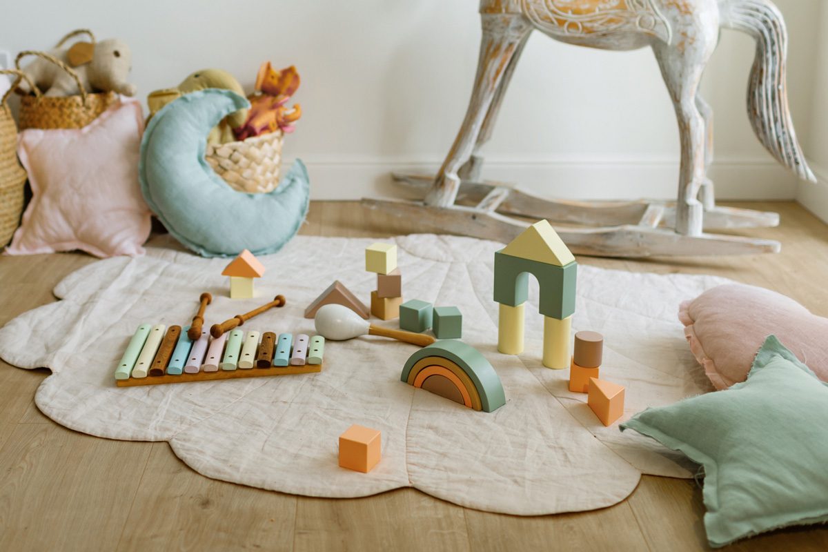 children's toys on linen rug with baskets in the background