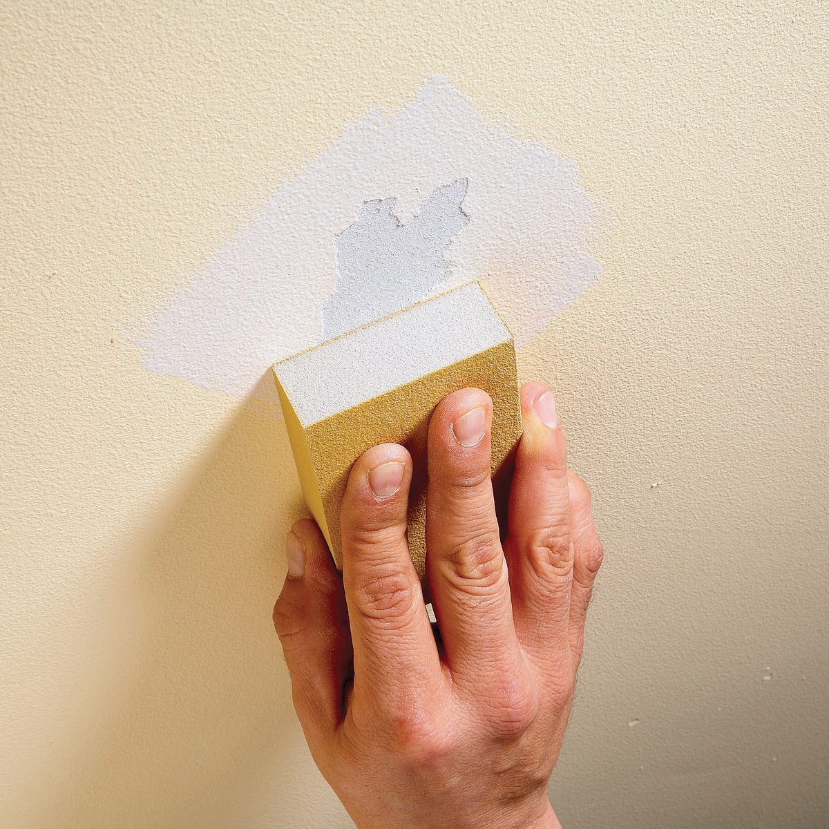sanding a wall